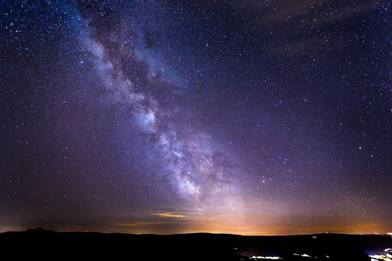 Starry night sky over a meadow